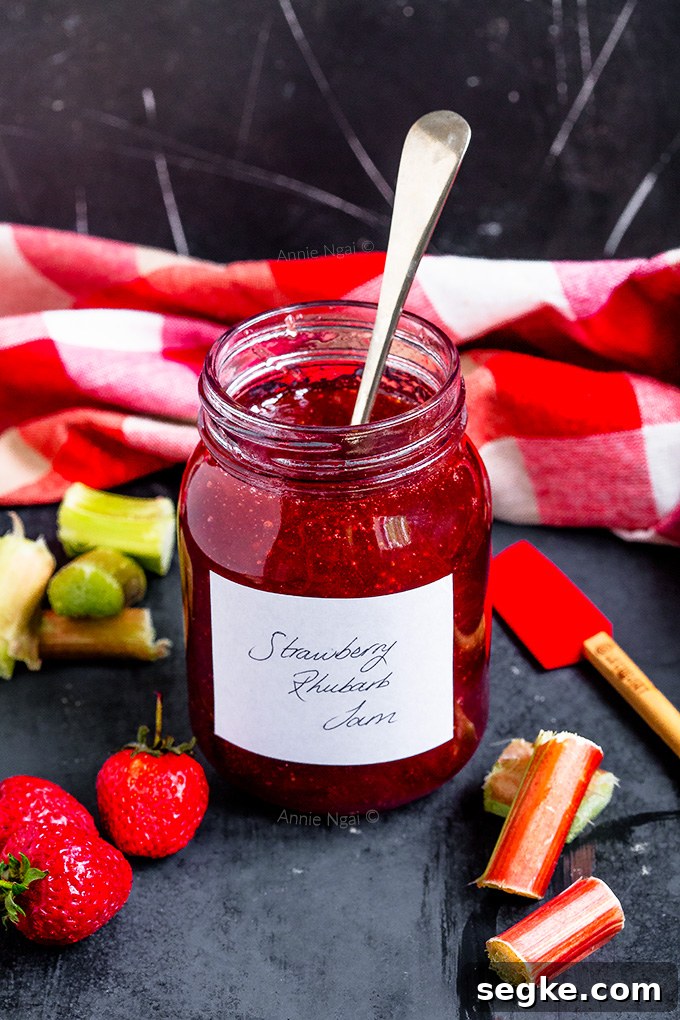 Jar of strawberry rhubarb jam on a table