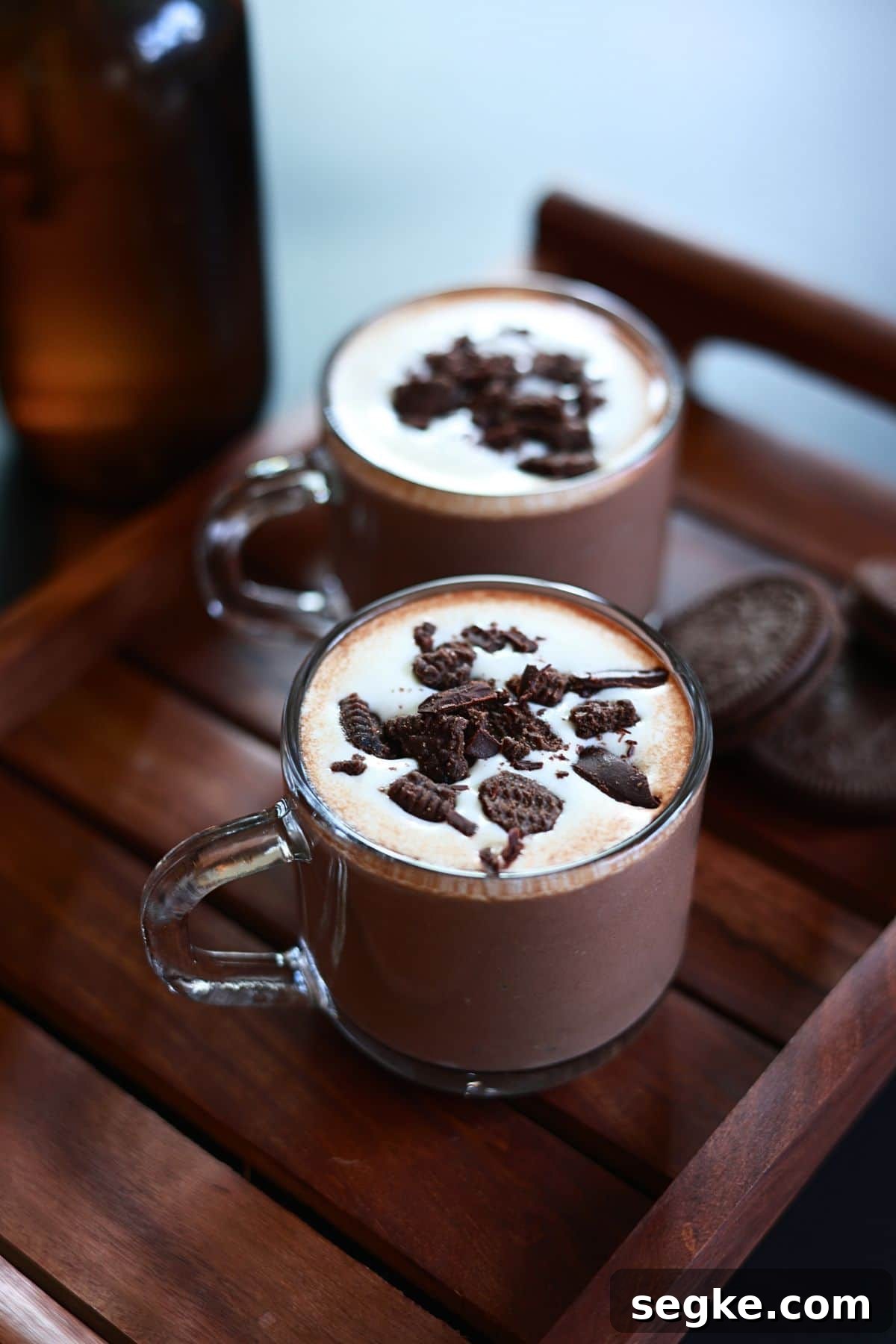 Oreo hot chocolate served in two glass cups.