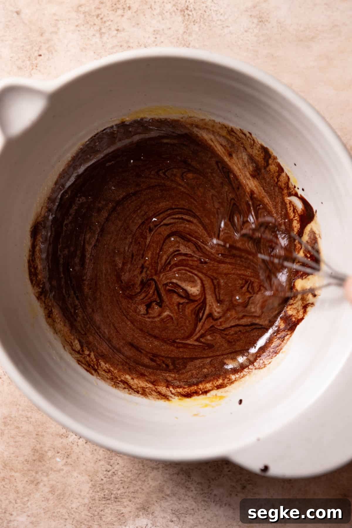 whisking the melted chocolate mixture into the egg mixture.