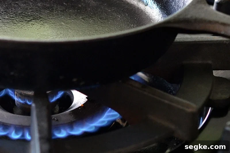 A cast iron skillet on top of a gas range.