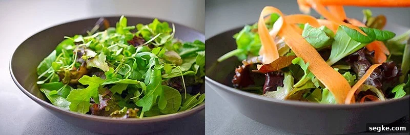 A brown shallow bowl is filled with salad greens and carrot ribbons.