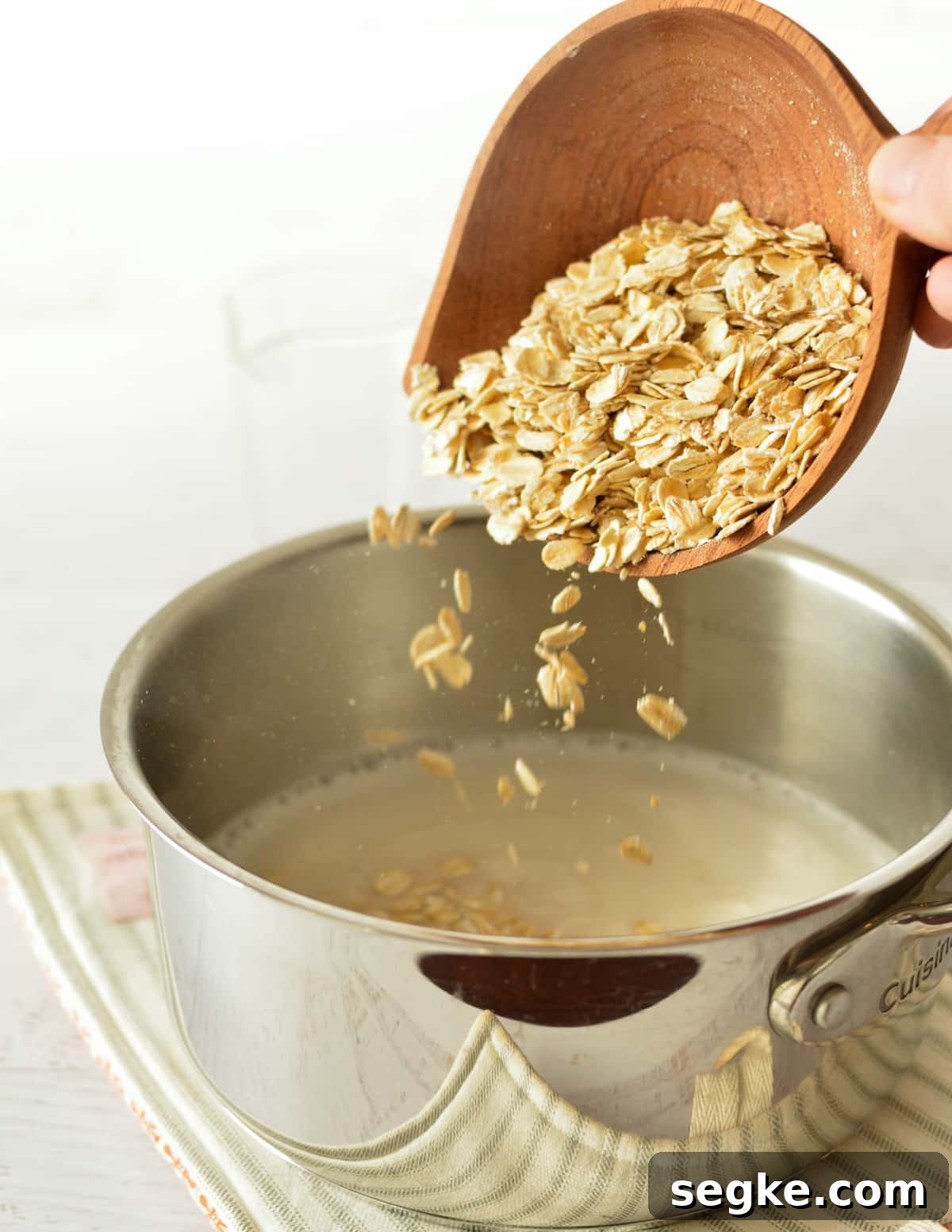 pouring oats into a saucepan with milk.