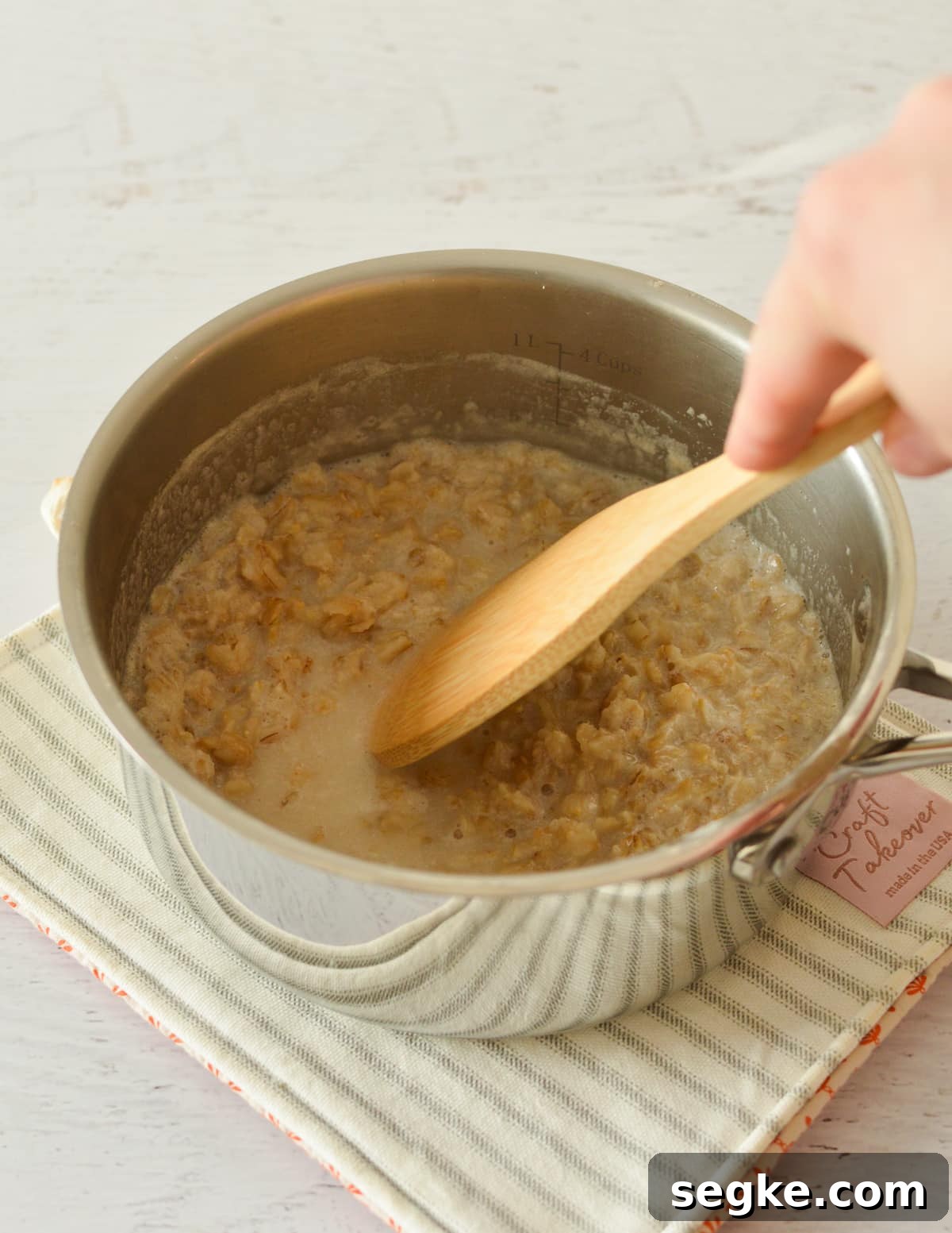 stirring oatmeal in a pan.