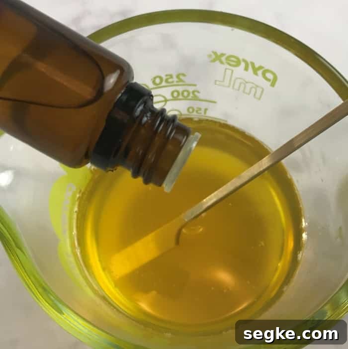 Adding essential oils to the mixture.
