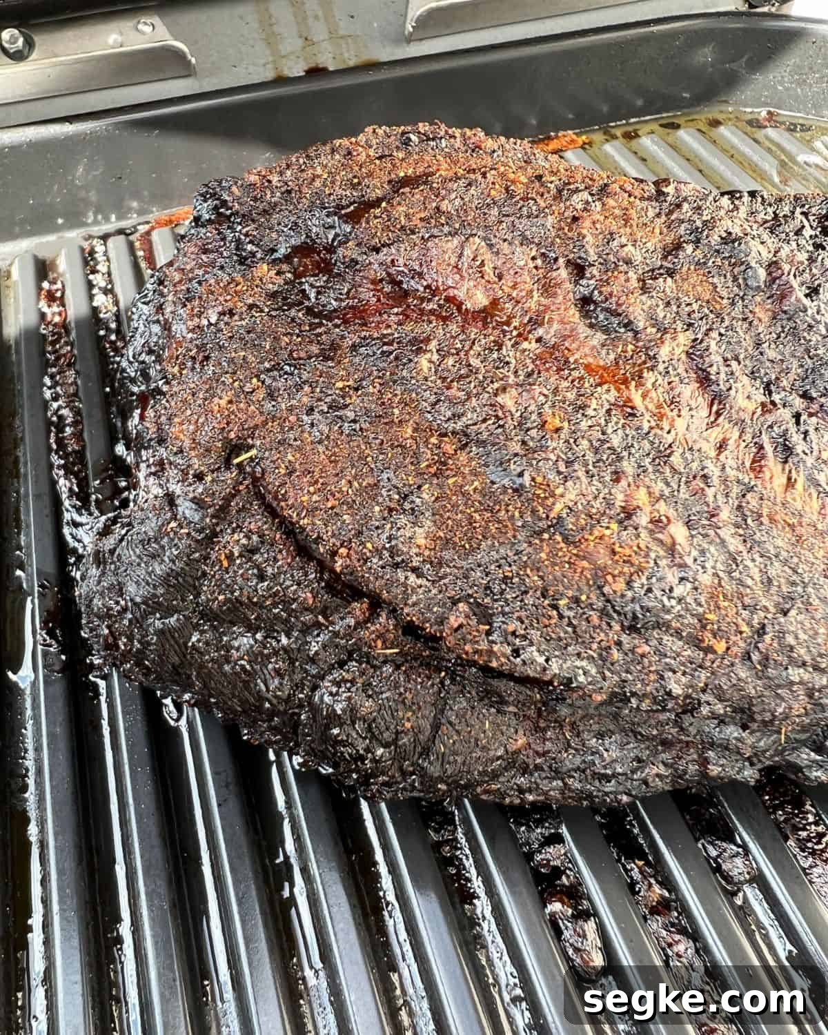 Finished smoked pork roast on a grill.