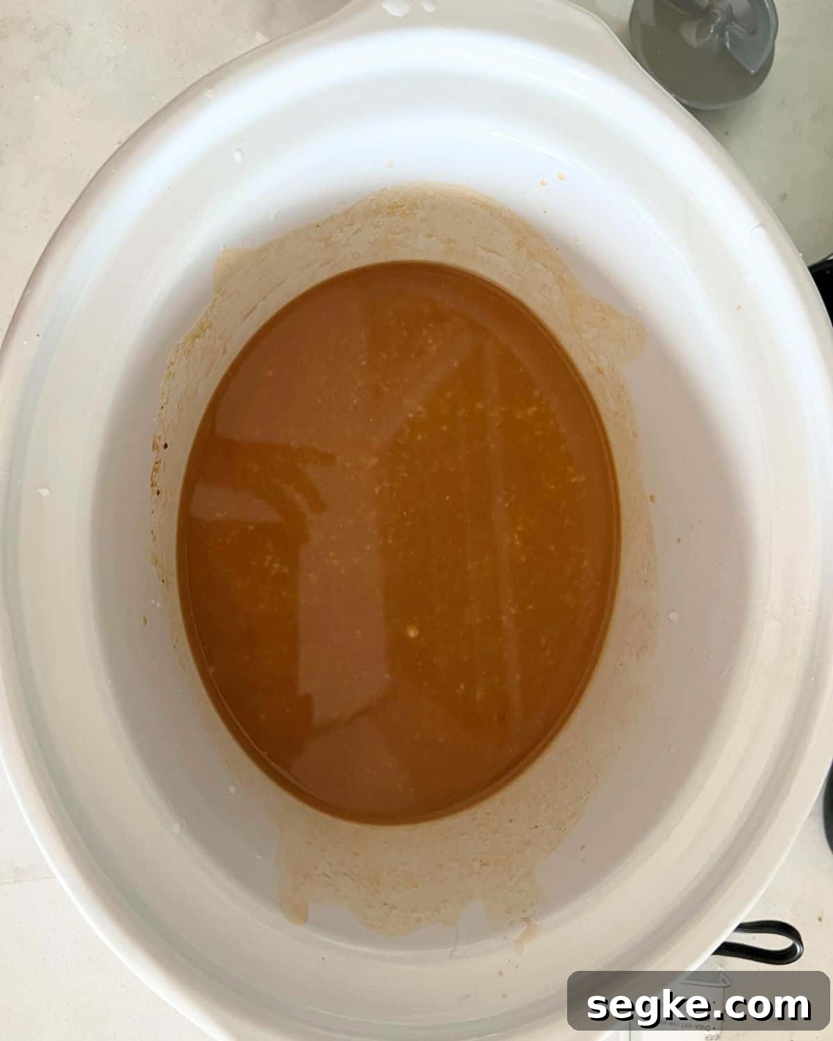 Mixed gravy ingredients in crock pot.