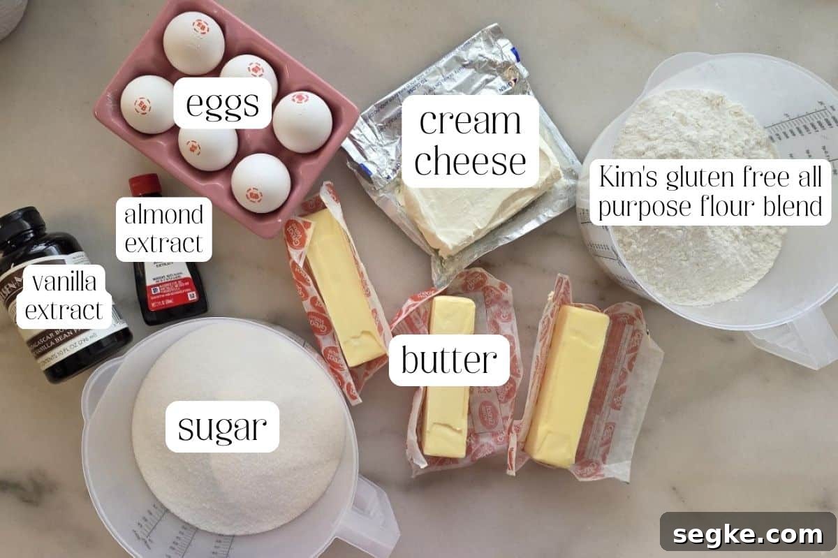Moist Gluten-Free Pound Cake Recipe 2 pound cake ingredients measured out and labeled on marble surface.