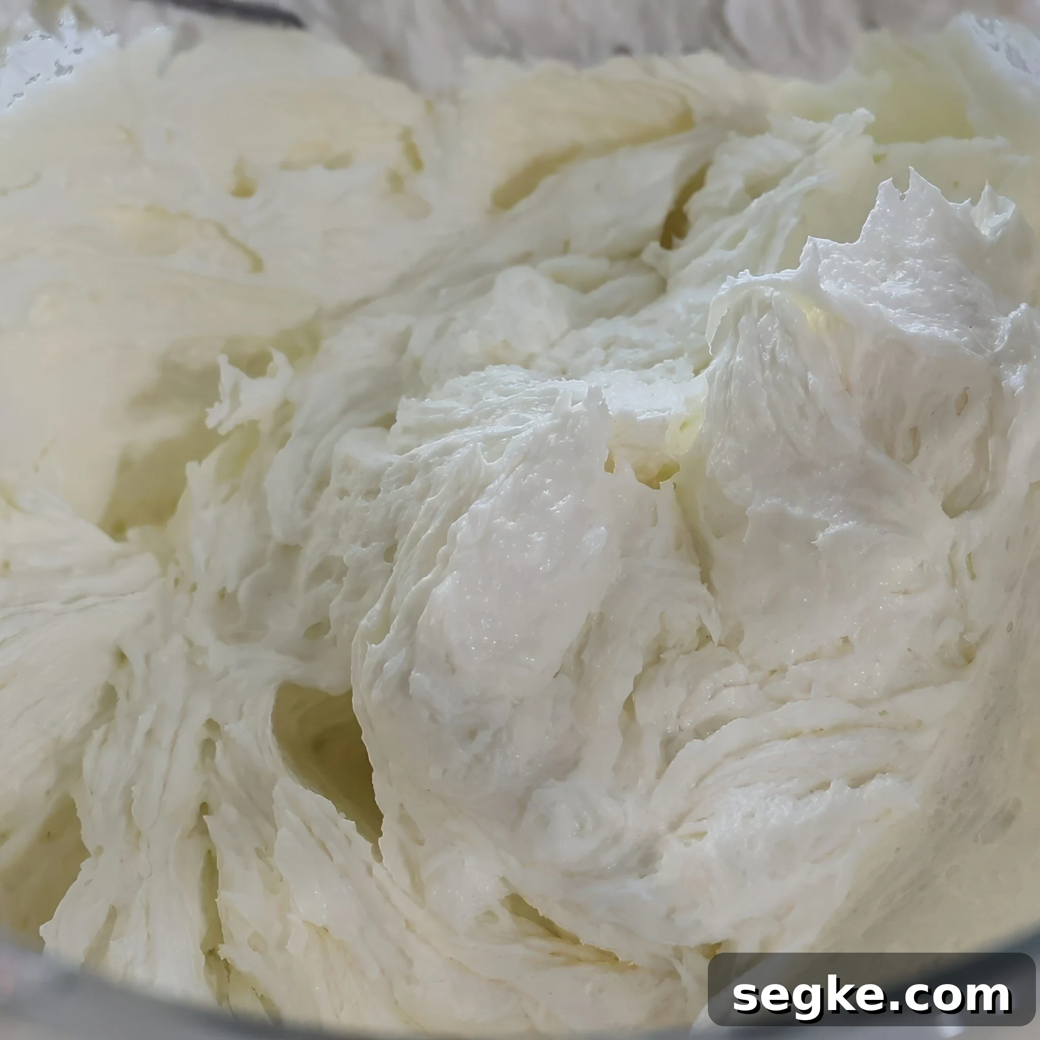 Moist Gluten-Free Pound Cake Recipe 3 close up of creamed butter and sugar in mixing bowl.