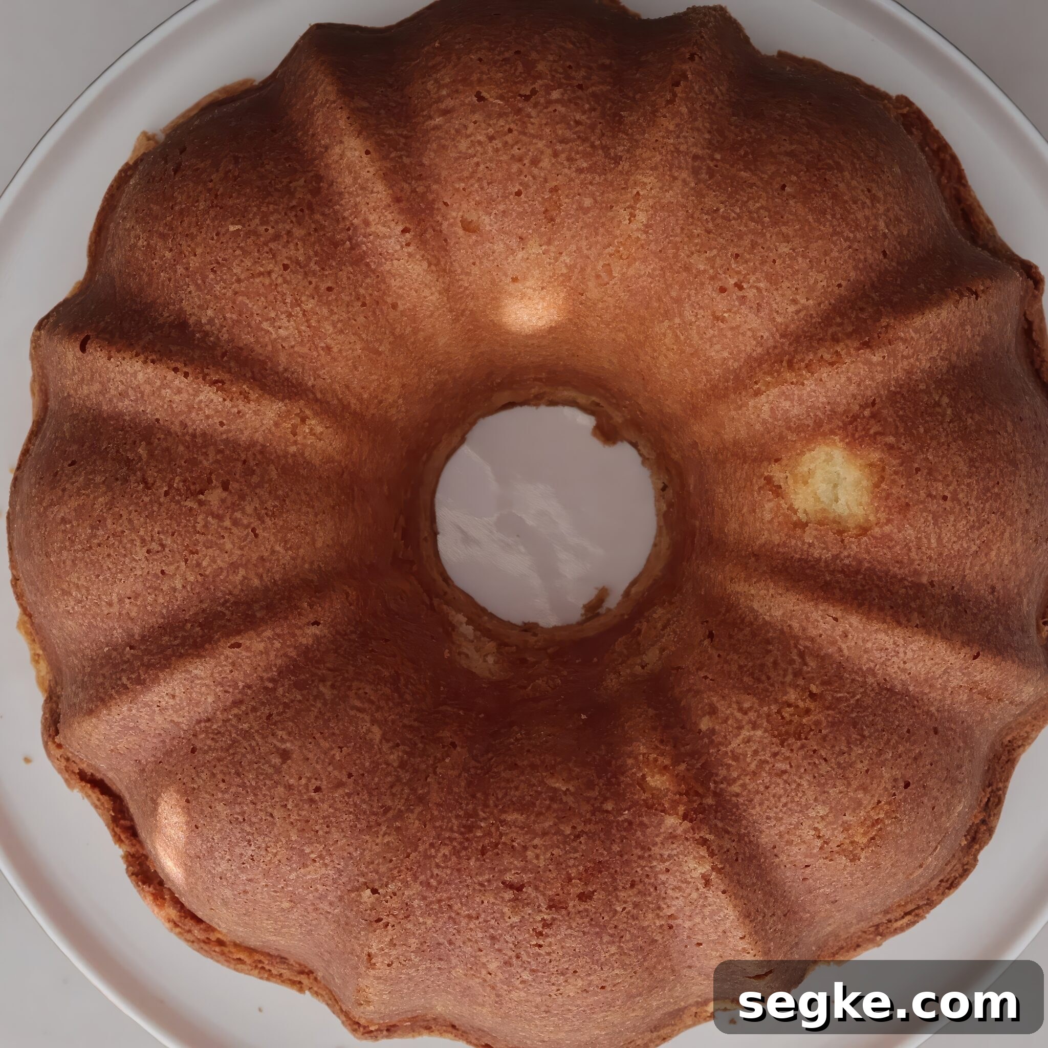 Moist Gluten-Free Pound Cake Recipe 8 pound cake on white cake stand.