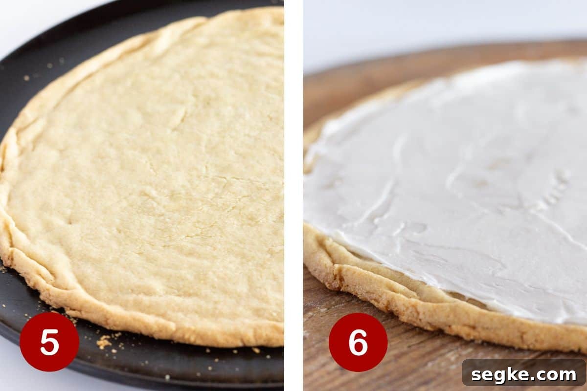 Baked cookie crust topped with cheesecake frosting spread in an even layer.