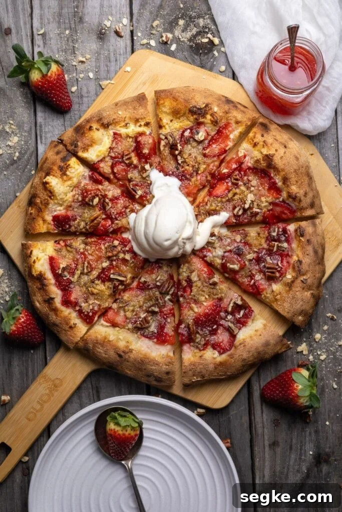 A sourdough strawberry crumble pizza topped with vanilla ice cream.