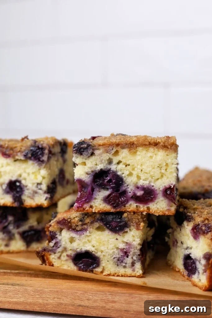 Sourdough blueberry buckle that has been sliced and stacked to display the blueberries inside.