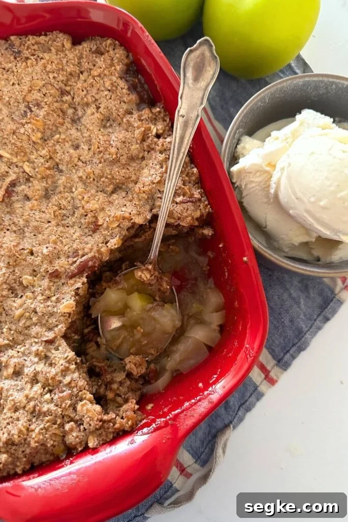 Sourdough apple crisp baked in a red baking dish.