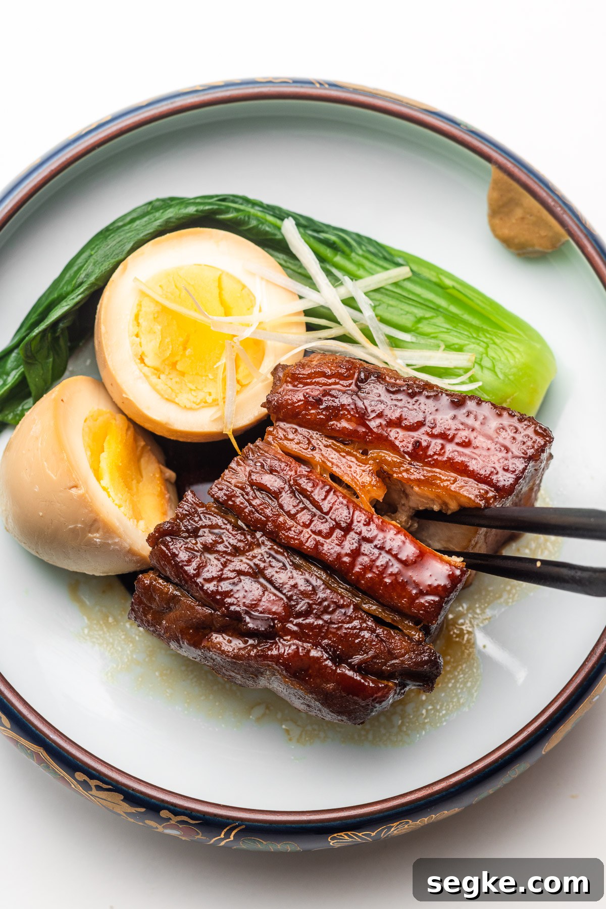 slicing into tender braised pork belly