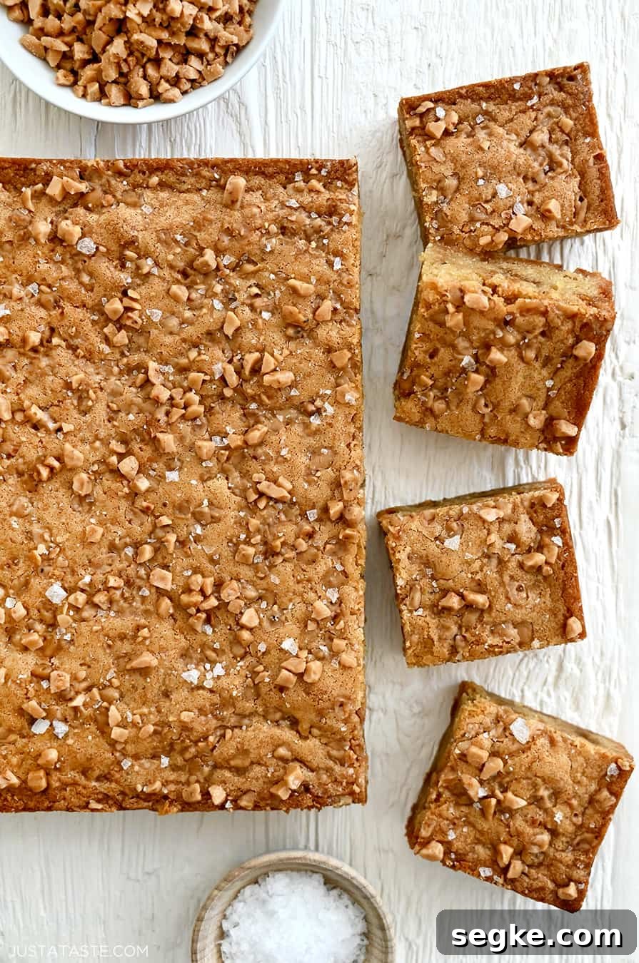 Spooky Halloween Dessert Recipes to Impress Guests 18 A top-down view of toffee blondies topped with toffee bits and large-flake sea salt.
