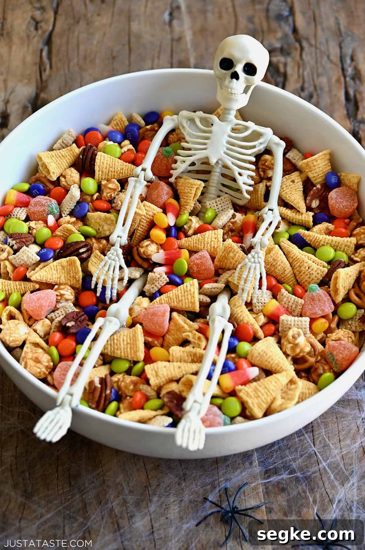 Spooky Halloween Dessert Recipes to Impress Guests 19 Easy Halloween snack mix with Chex cereal, pecans, candy corn, mini pretzels and M&Ms in a large serving bowl.