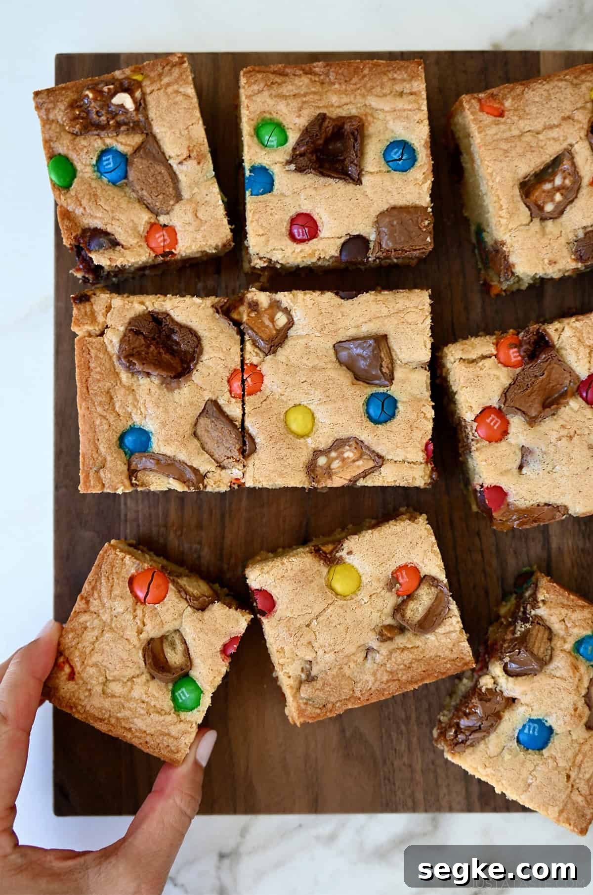 Spooky Halloween Dessert Recipes to Impress Guests 21 Leftover Halloween candy blondies cut into squares.