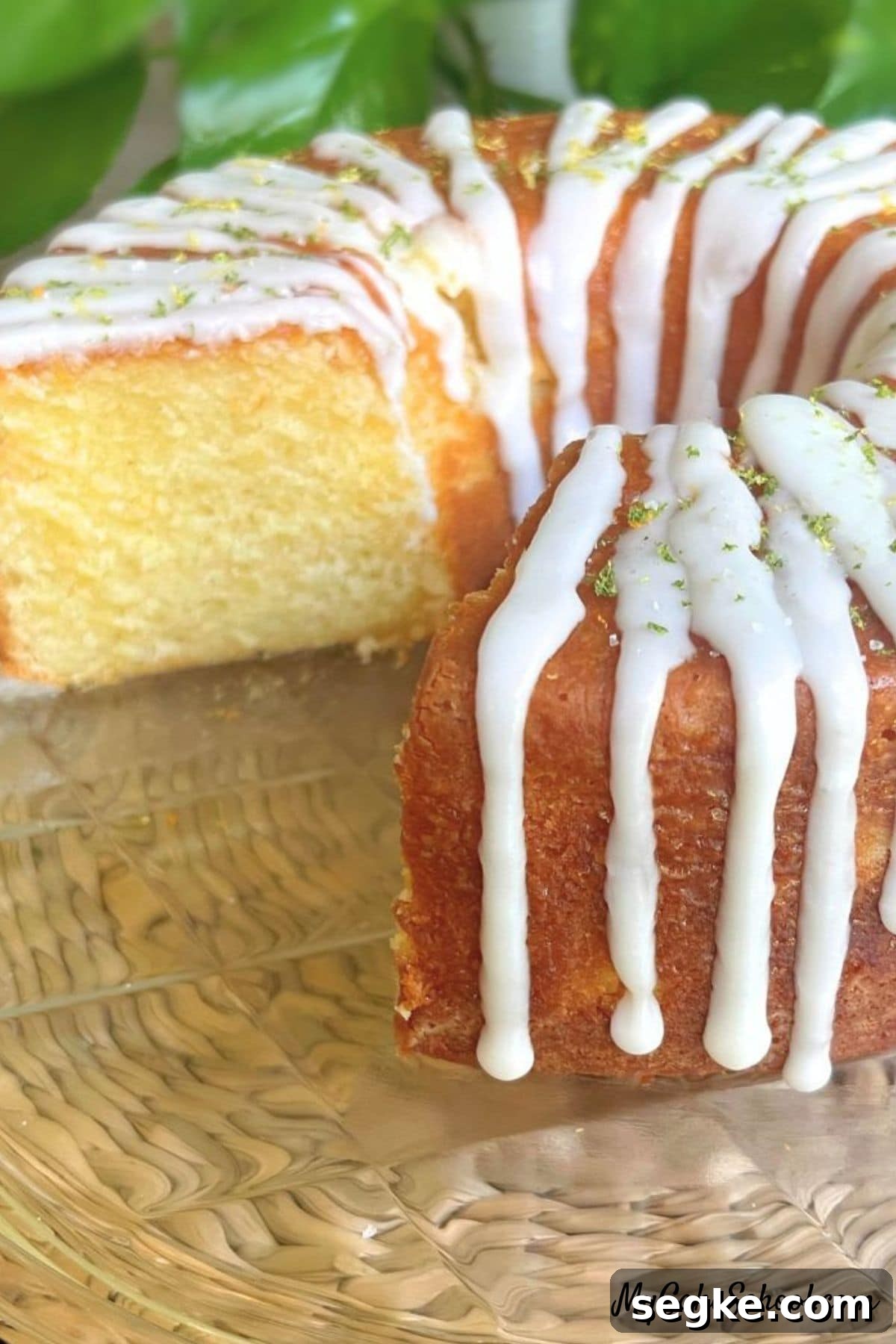 Margarita Pound Cake with Tequila Lime Glaze 2 Margarita Pound Cake, sliced, on a cake plate.