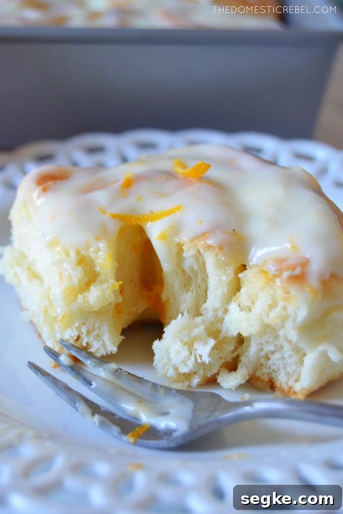 Zesty Orange Glazed Sweet Rolls Recipe 6 Closeup of a broken open orange sweet roll on a plate