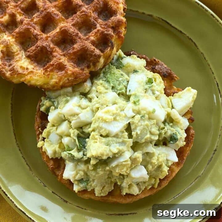 Healthy avocado egg salad made without mayo or yogurt on a chaffle.