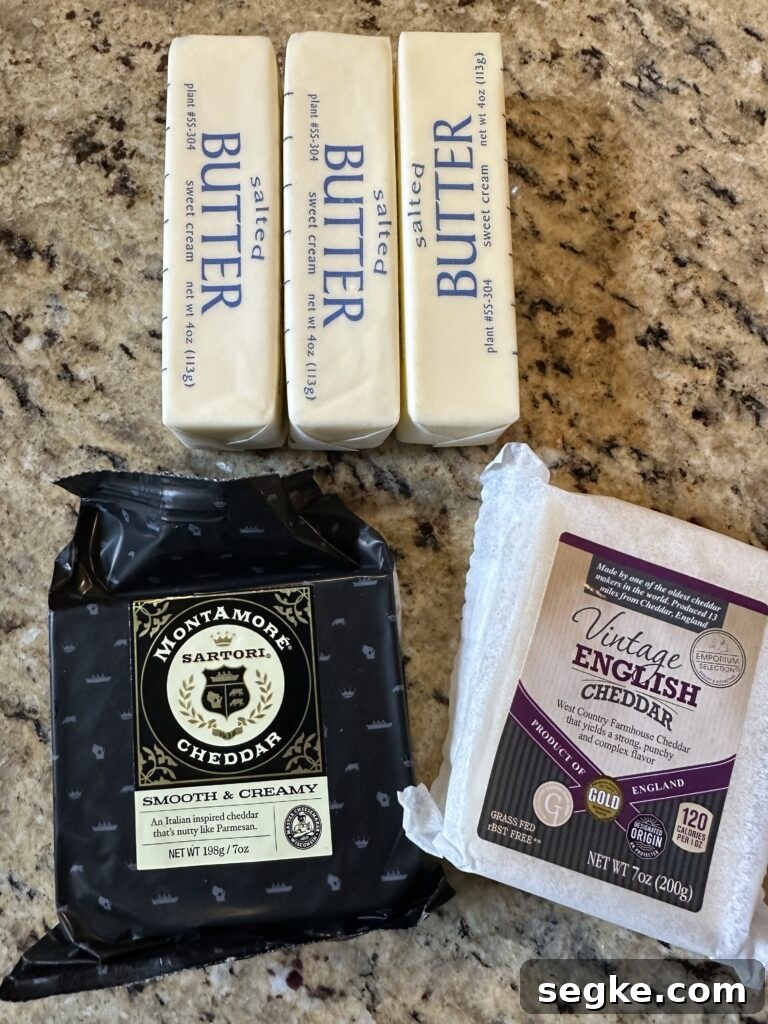 Three sticks of butter, and two packages of two different types of cheddar