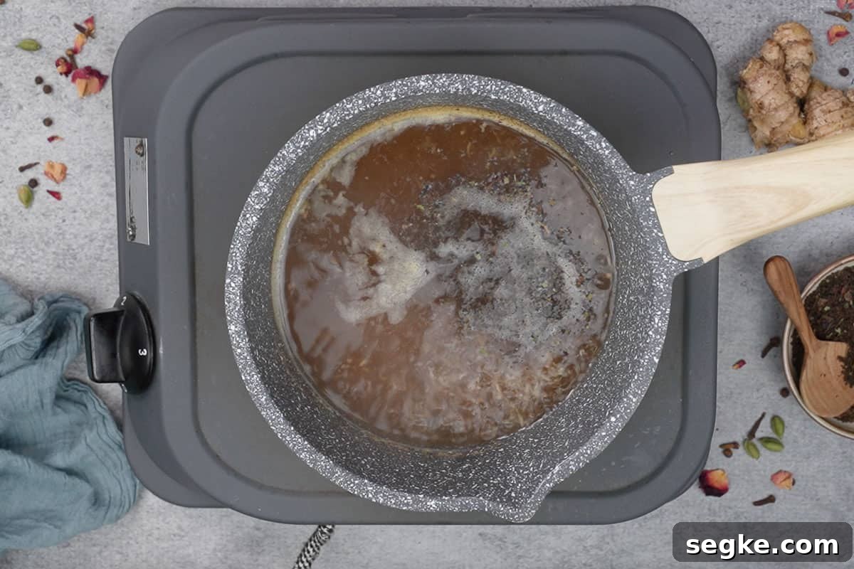 Black tea leaves and sugar added to the pan.