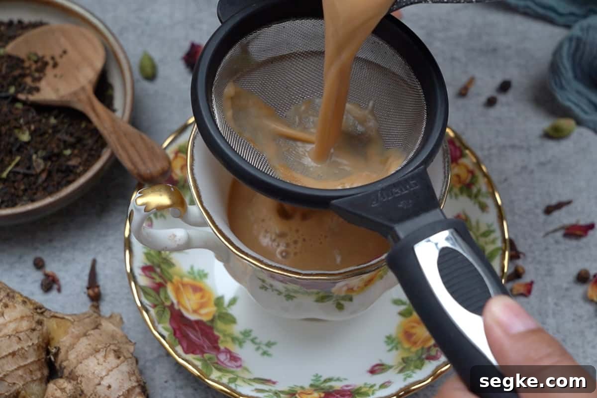 Straining the tea in the cup.
