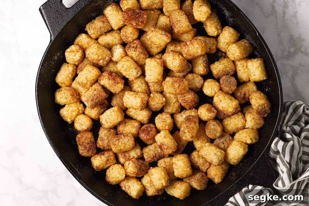 Seasoned tater tots in a cast iron skillet 