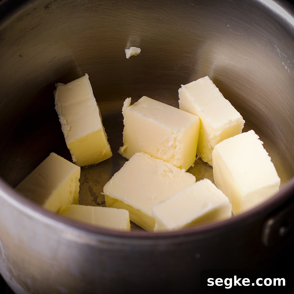 Chunks of butter in a saucepan.