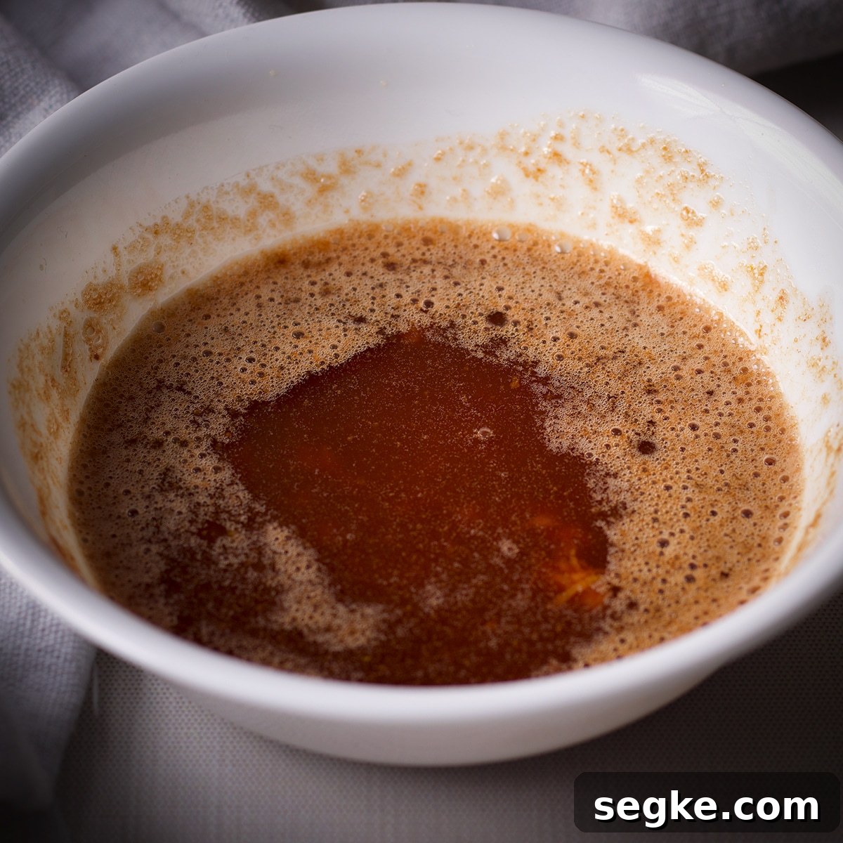 A white bowl filled with brown butter.