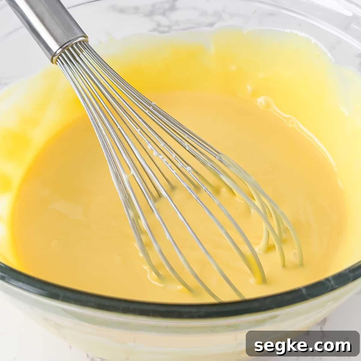 Whisking in the sweetened condensed milk.