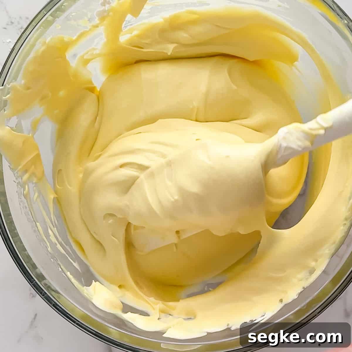 Folding in the whipping cream into the banana pudding.
