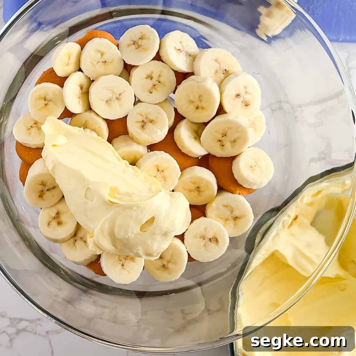 Layering the pudding, bananas, and nilla wafers.