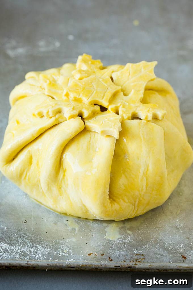 Baked Brie with Raspberries and Toasted Pecans Recipe 3 Cheese wrapped in puff pastry and topped with egg wash.