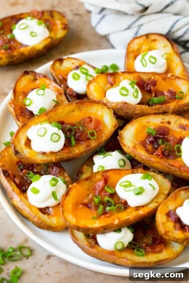 Baked Brie with Raspberries and Toasted Pecans Recipe 6 A serving plate of potato skins topped with bacon and sour cream.