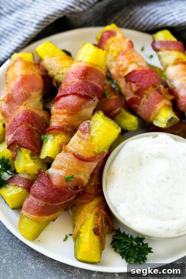 Baked Brie with Raspberries and Toasted Pecans Recipe 9 Bacon wrapped pickles on a plate with a side of ranch dressing.