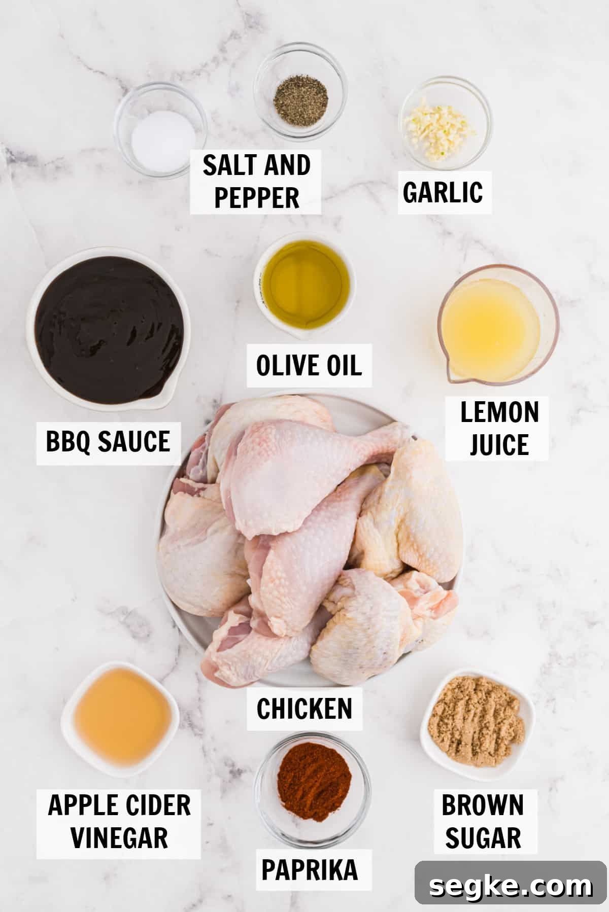 all of the ingredients for baked bbq chicken on a white counter