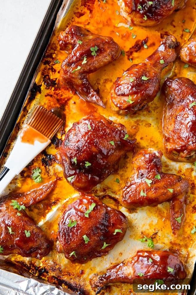 Baked bbq chicken includes a simple seasoning and easy bbq sauce that coasts wings, thighs and drumsticks that are baked in the oven. #bbq #chicken #wings #thighs #drumsticks #homemade #healthy #recipe
