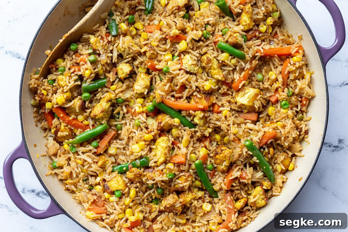 tofu fried rice with veggies in large purple skillet