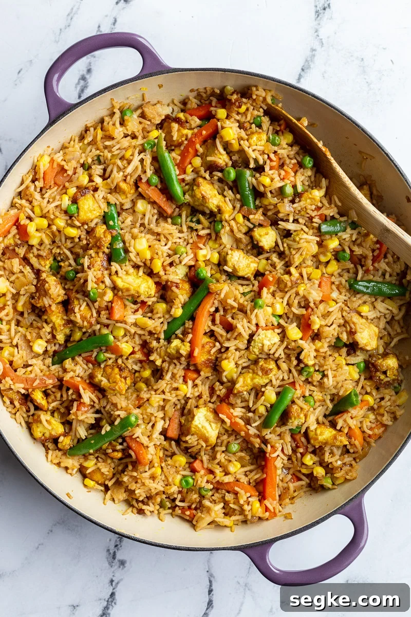 tofu fried rice with veggies in large purple skillet