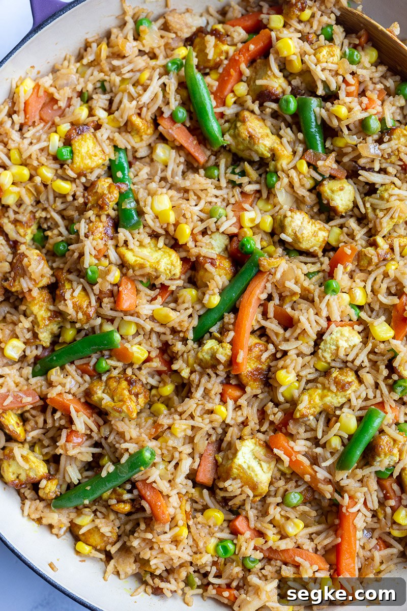 tofu fried rice with veggies in large purple skillet