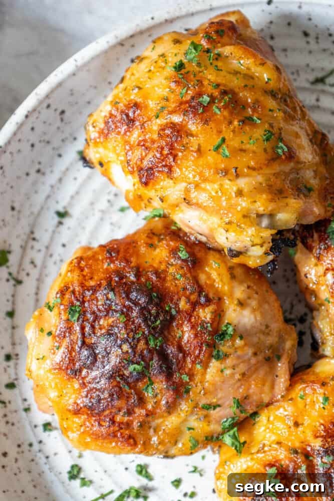 Crispy Oven-Baked Ranch Chicken Thighs 5 Plated baked ranch chicken thighs with herbs