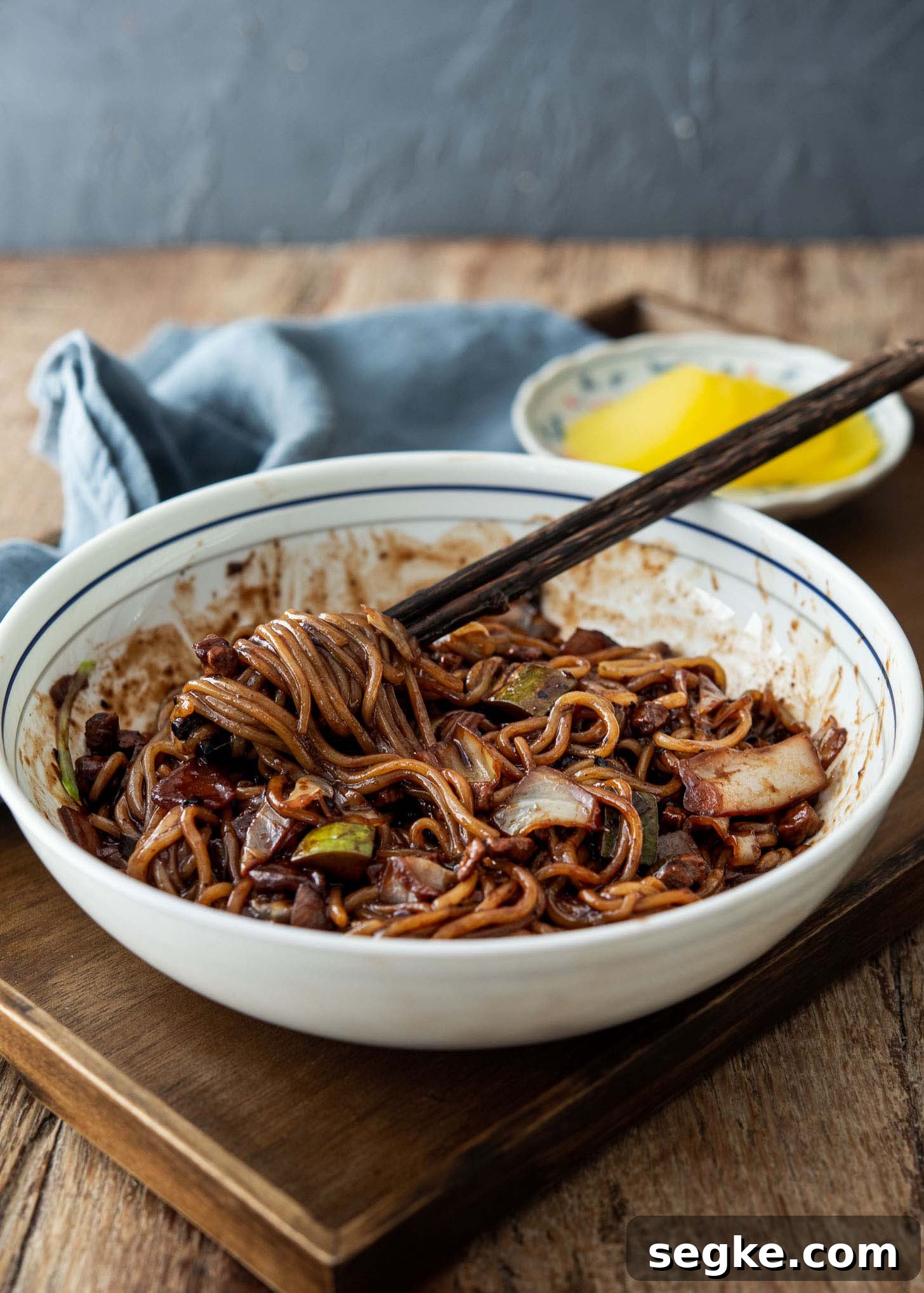 Jajangmyeon Recipe: Korean Black Bean Noodles 9 Korean black bean noodles with chopsticks and danmuji.