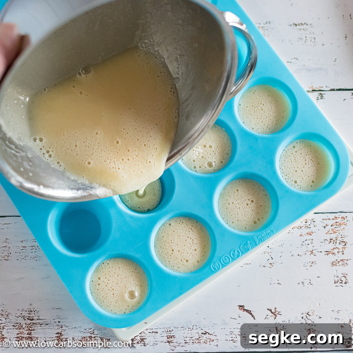 Keto Eggnog Gummies for Low-Carb Holiday Treats 9 Pouring Mixture into Silicone Minimuffin Pan | Low-Carb, So Simple