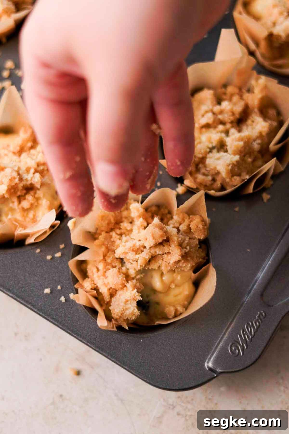 Blackberry Muffins Recipe: Fluffy, Juicy, Homemade 10 sprinkling crumble on top of muffin batter