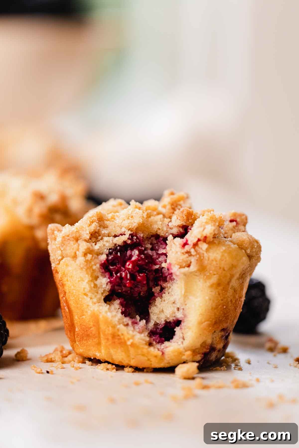 Blackberry Muffins Recipe: Fluffy, Juicy, Homemade 12 bitten blackberry buttermilk muffin with crumble