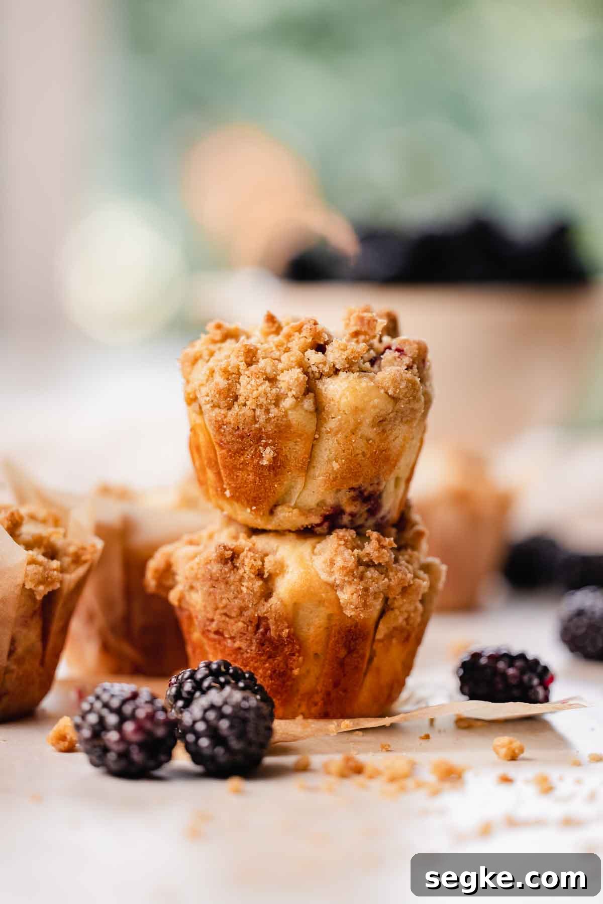 Blackberry Muffins Recipe: Fluffy, Juicy, Homemade 15 two blackberry muffins stacked on top of eachother
