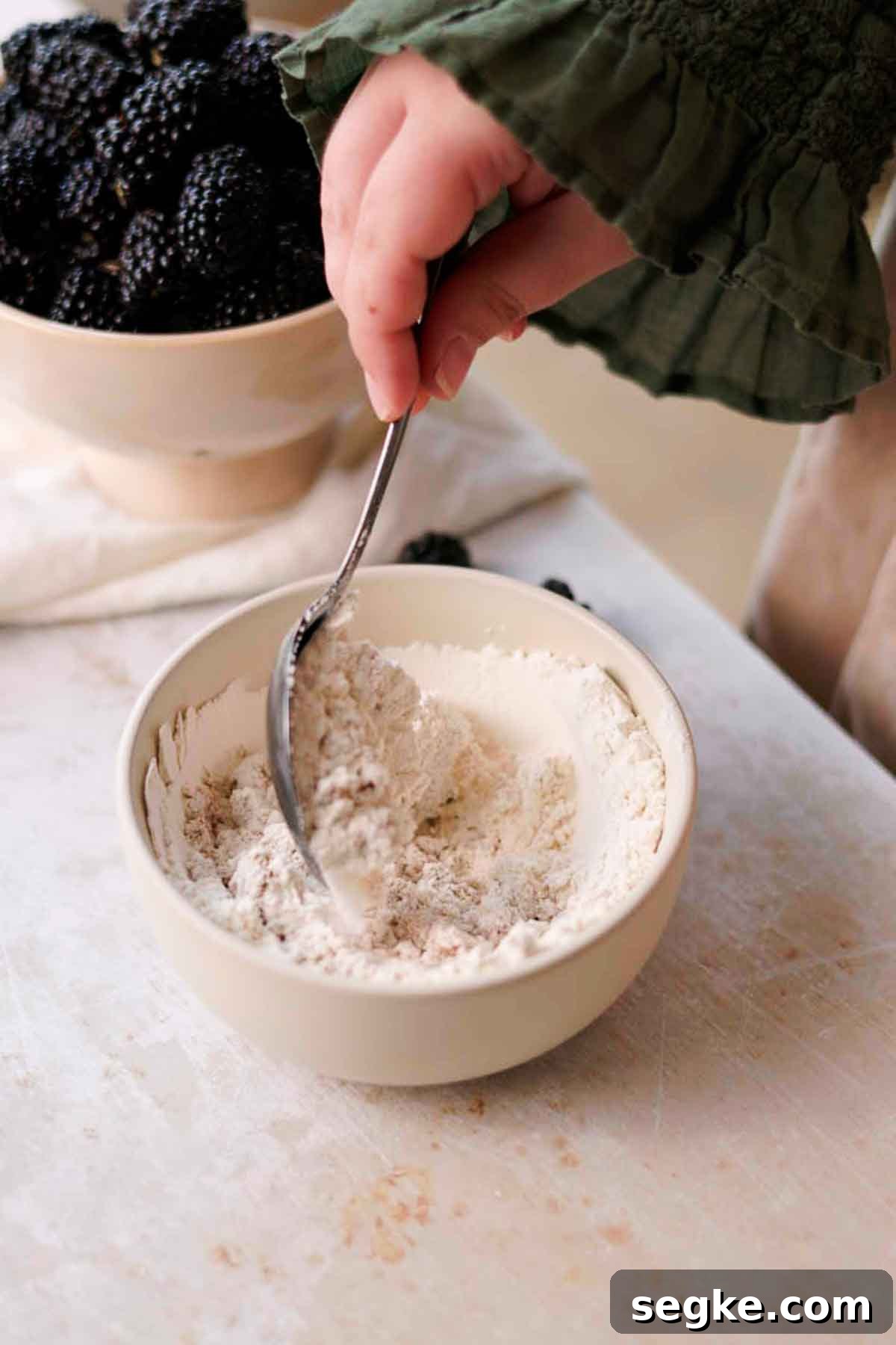 Blackberry Muffins Recipe: Fluffy, Juicy, Homemade 4 stirring flour and sugar together
