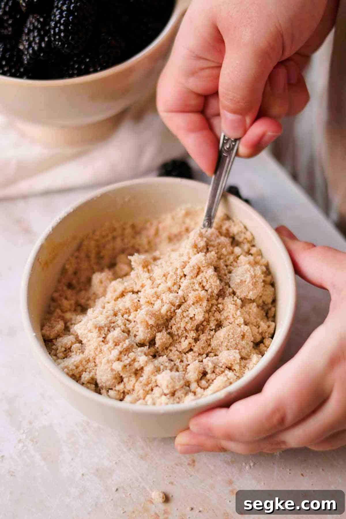 Blackberry Muffins Recipe: Fluffy, Juicy, Homemade 5 mixing crumble together in bowl
