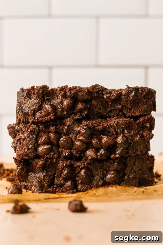 Gluten-Free Chocolate Zucchini Bread (Grain-Free Paleo Recipe) 5 Gluten free chocolate zucchini bread slices stacked on parchment paper.